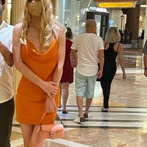 Zerina Akers bright orange dress